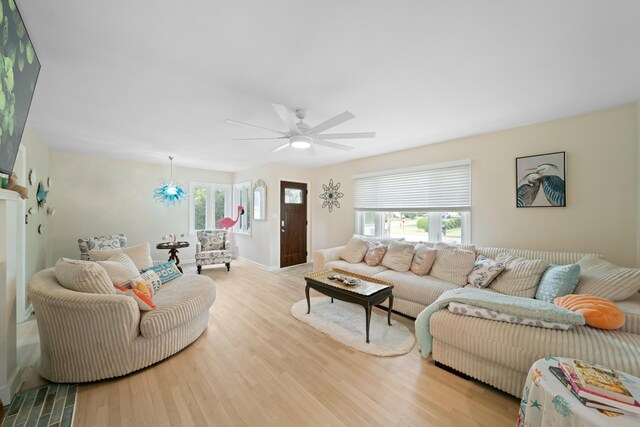 living room with ceiling fan, a wealth of natural light, and light hardwood / wood-style flooring