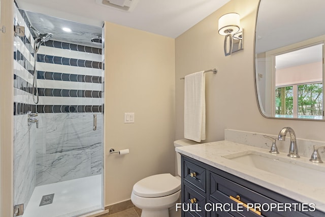 bathroom with tile patterned flooring, vanity, toilet, and walk in shower