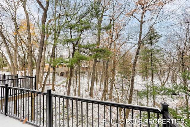 view of snow covered back of property