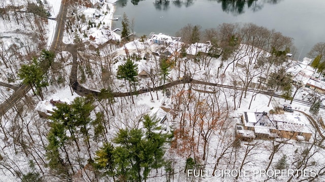 snowy aerial view featuring a water view