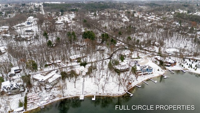 snowy aerial view with a water view