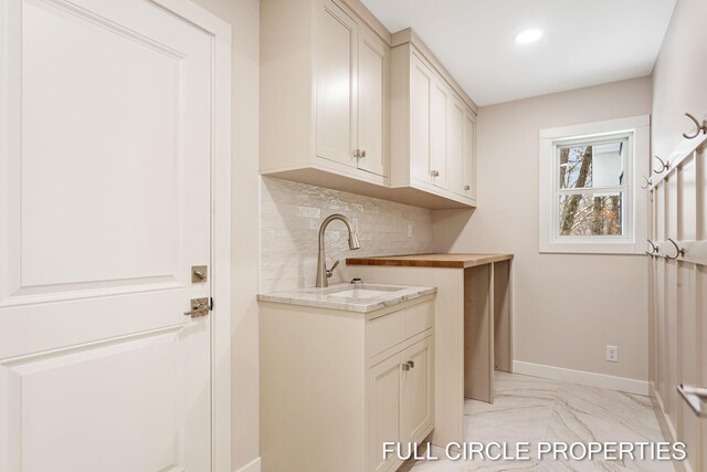 washroom featuring light tile patterned floors and sink