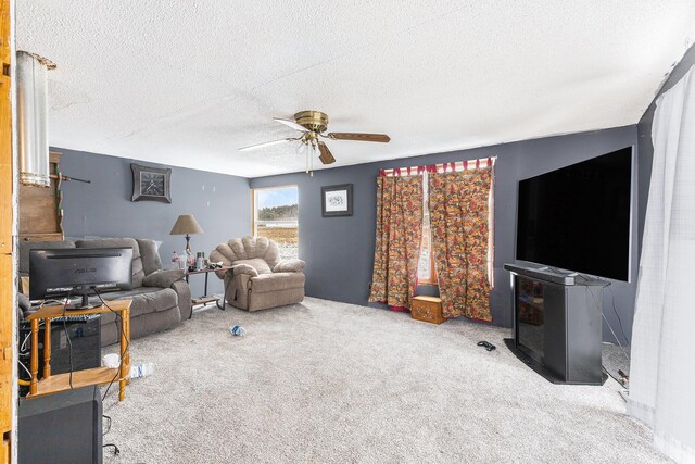 carpeted living room with ceiling fan and a textured ceiling