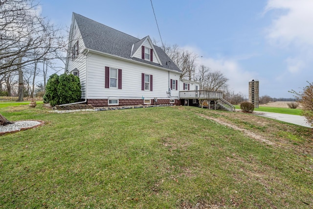 view of front facade featuring a front lawn and a deck