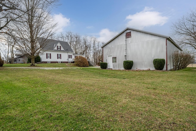 view of property exterior with an outbuilding and a yard