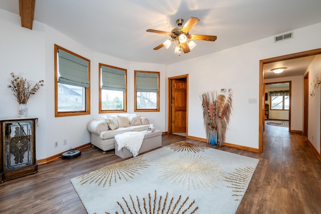 unfurnished living room featuring ceiling fan, dark hardwood / wood-style flooring, and a healthy amount of sunlight