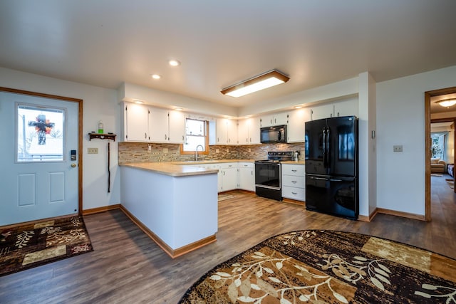 kitchen with black appliances, white cabinets, dark wood-type flooring, and tasteful backsplash