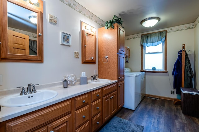 bathroom with washer / dryer, vanity, and wood-type flooring