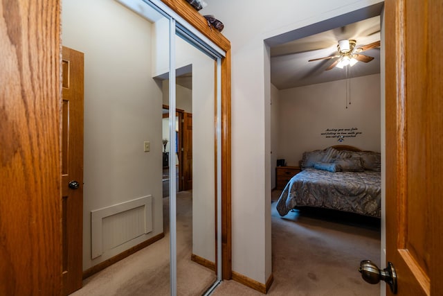 bedroom with ceiling fan and light colored carpet