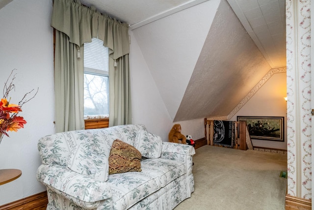 living area featuring carpet flooring and lofted ceiling