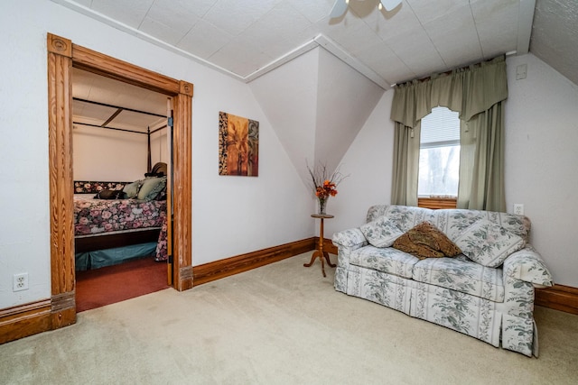 sitting room featuring carpet, vaulted ceiling, and ceiling fan