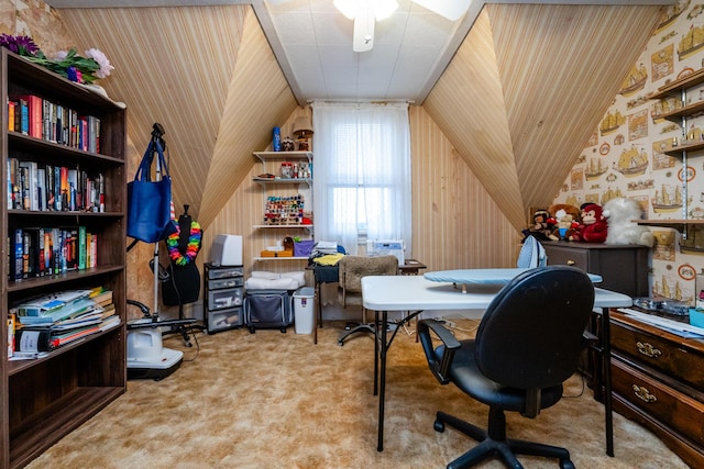 office space with wood walls, light colored carpet, and lofted ceiling