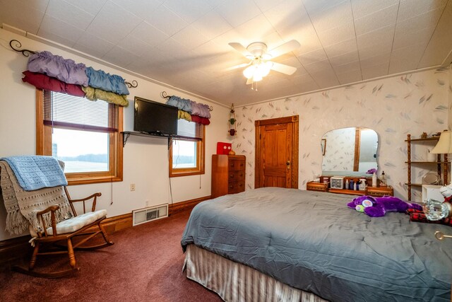 bedroom featuring carpet, ceiling fan, and crown molding