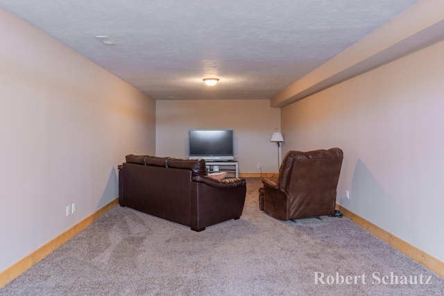 living room featuring a textured ceiling and light colored carpet