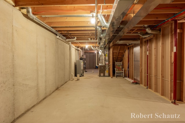 basement featuring gas water heater and heating unit