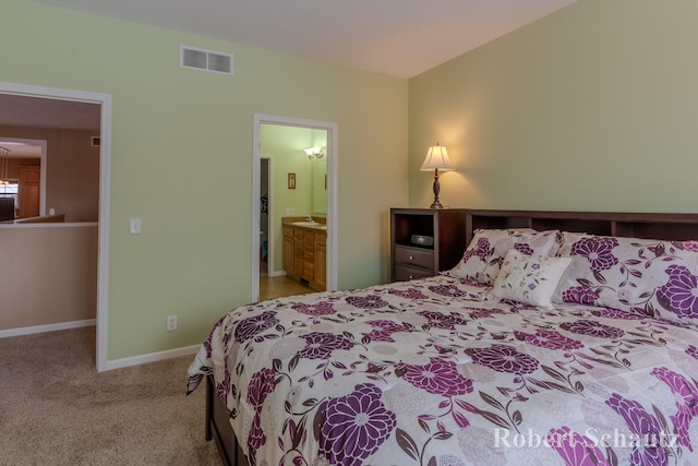 carpeted bedroom with ensuite bath