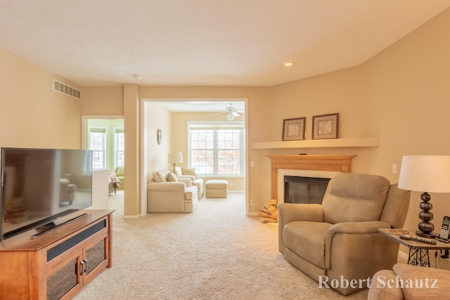 carpeted living room featuring ceiling fan