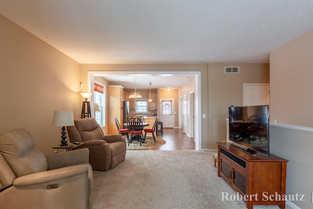 living room with hardwood / wood-style flooring and a notable chandelier