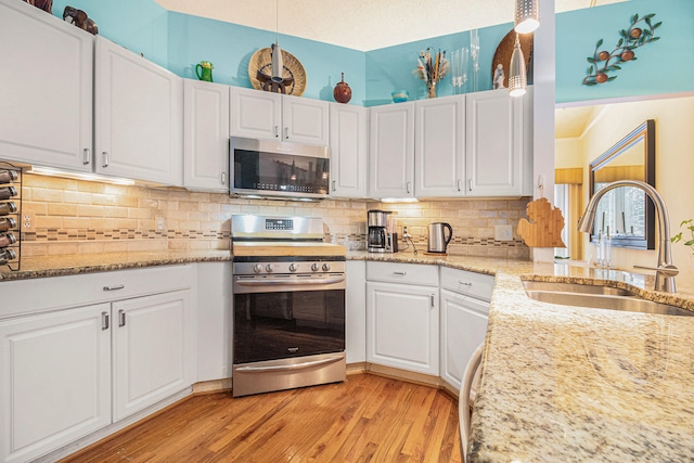 kitchen with white cabinetry and appliances with stainless steel finishes