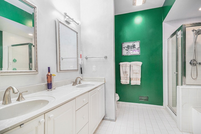 bathroom with toilet, vanity, tile patterned floors, and a shower with door