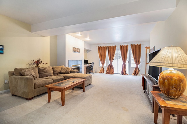 carpeted living room with a fireplace