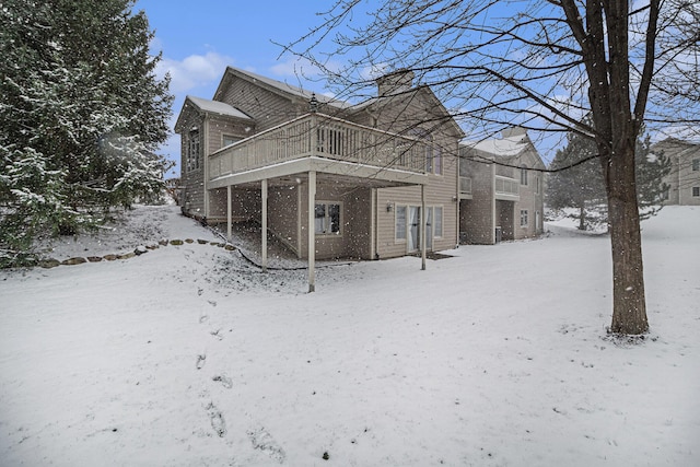 view of snowy exterior with a deck