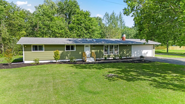 single story home featuring a front lawn and a garage