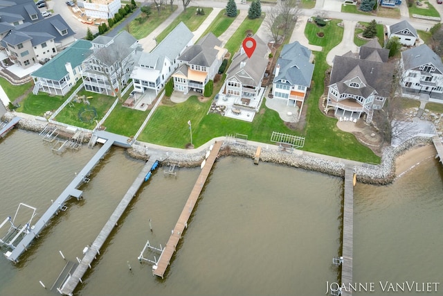 drone / aerial view featuring a residential view and a water view