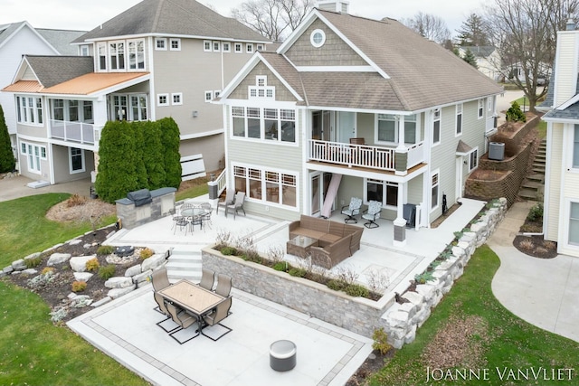 rear view of house featuring outdoor dining area, outdoor lounge area, a chimney, and a patio area