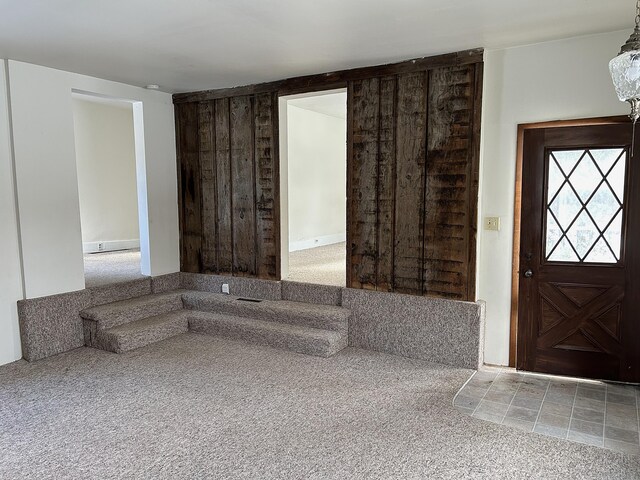 view of carpeted foyer entrance