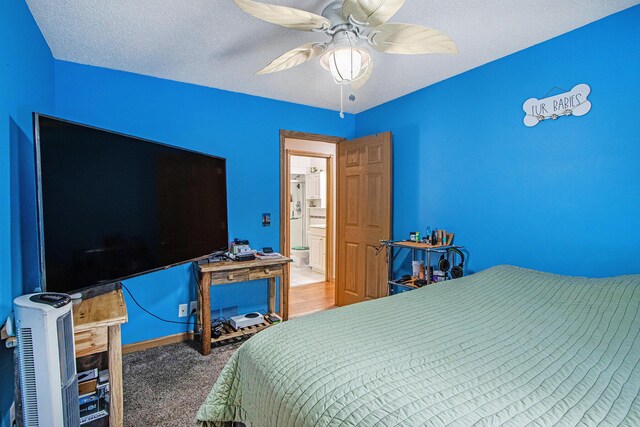 carpeted bedroom with ceiling fan and a textured ceiling