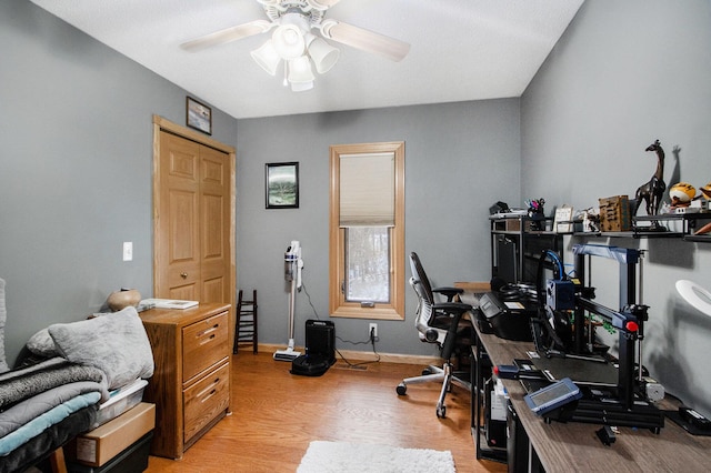 office space with ceiling fan and light hardwood / wood-style floors