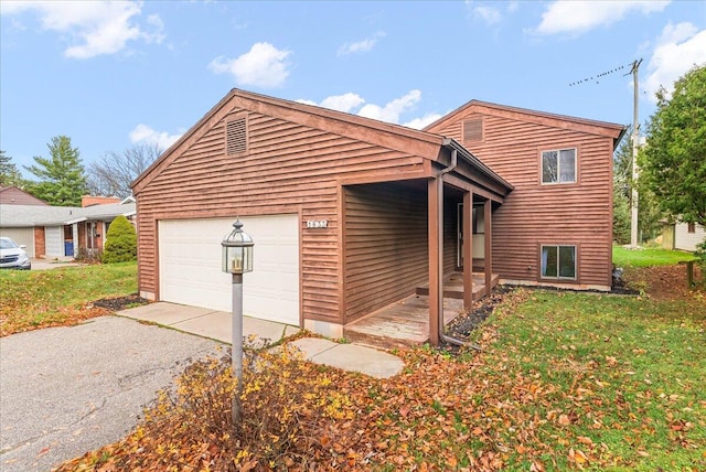 view of front of property with a garage and a front lawn