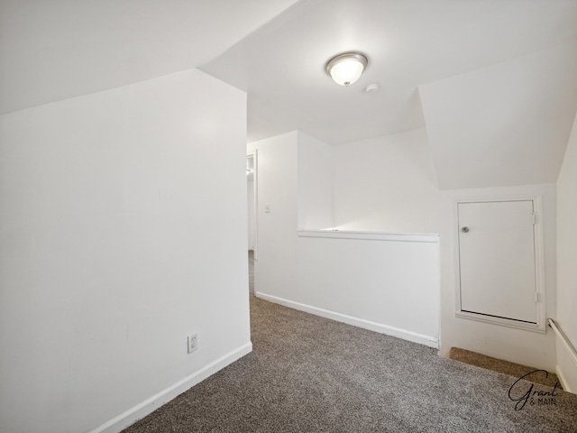 bonus room with carpet and vaulted ceiling