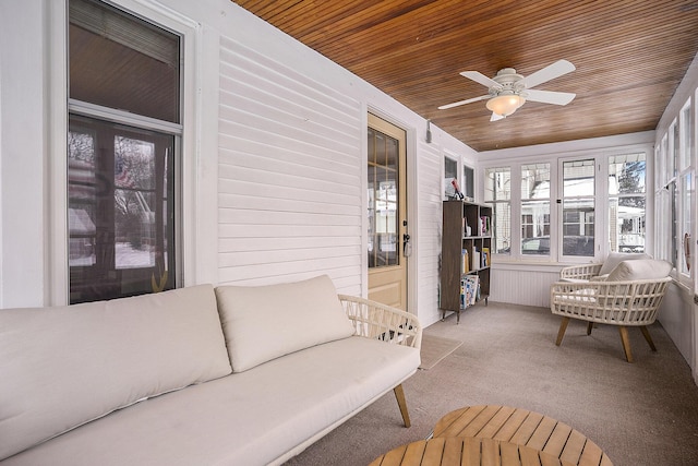 sunroom with ceiling fan and wooden ceiling