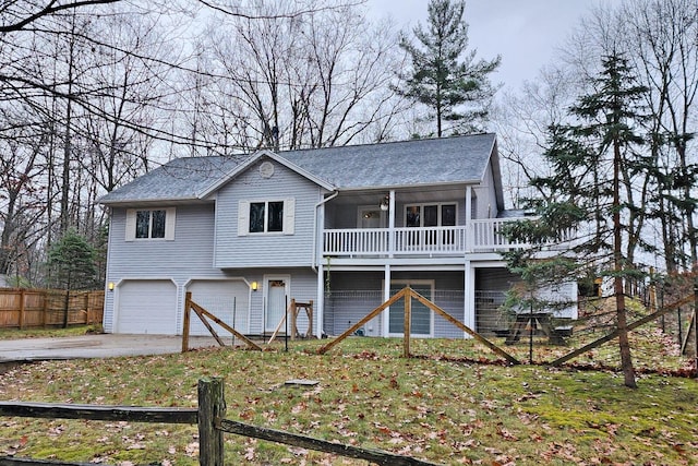 view of front of property with a garage and a sunroom