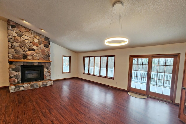 unfurnished living room with a textured ceiling, dark hardwood / wood-style flooring, and vaulted ceiling