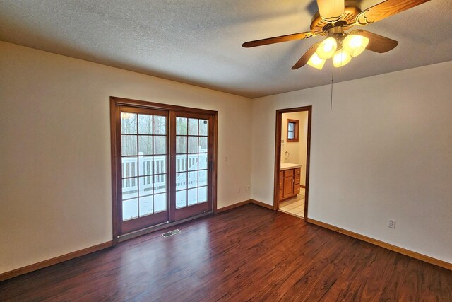 empty room with hardwood / wood-style floors, ceiling fan, and a textured ceiling