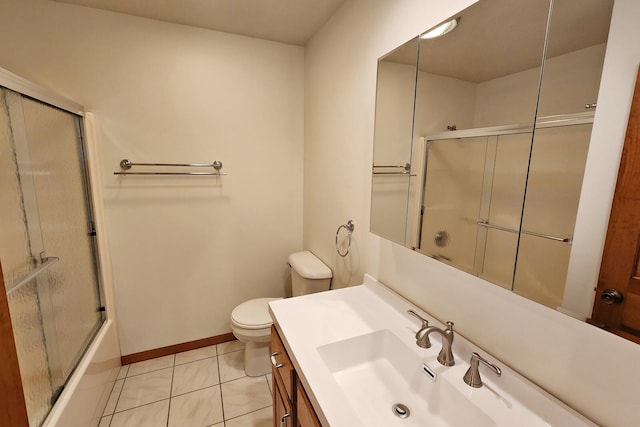 full bathroom featuring tile patterned floors, shower / bath combination with glass door, vanity, and toilet