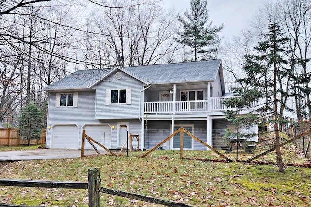 view of front facade with a garage, concrete driveway, fence, and stairs