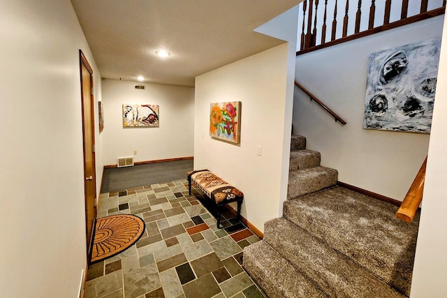 stairs featuring recessed lighting, visible vents, and baseboards