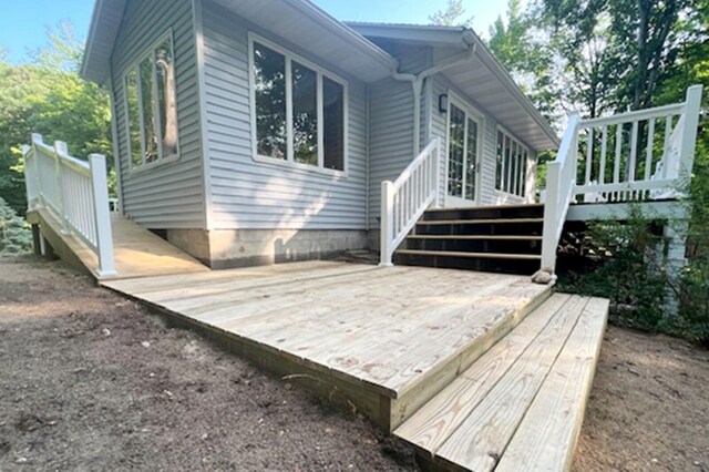 view of property exterior featuring a wooden deck