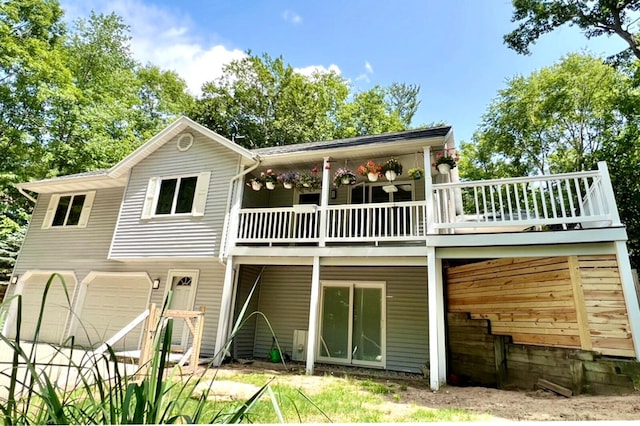 back of property with a garage and a wooden deck