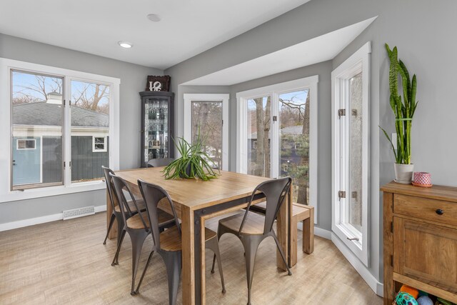 dining room featuring plenty of natural light and light hardwood / wood-style flooring