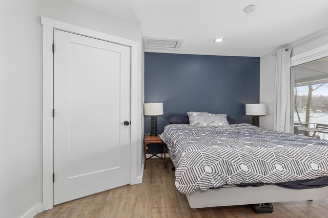 bedroom featuring hardwood / wood-style floors and a closet