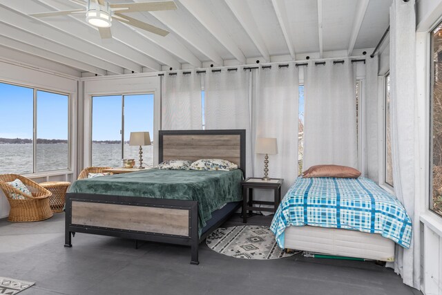 bedroom featuring ceiling fan, a water view, and concrete flooring