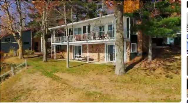 rear view of property featuring a balcony