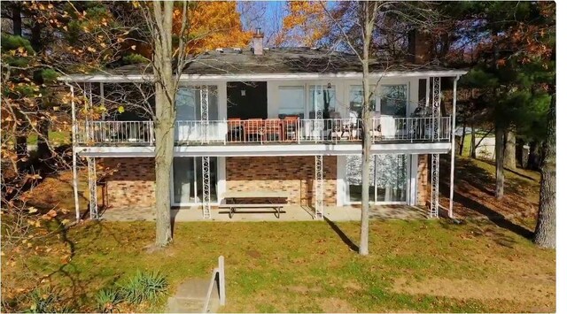 rear view of house with a lawn and a patio area