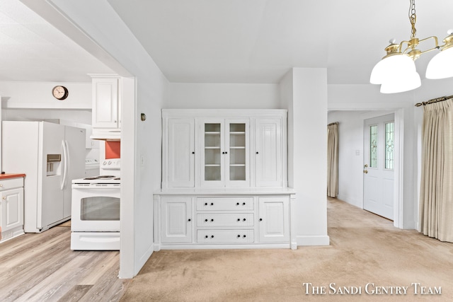 kitchen featuring white cabinets, light hardwood / wood-style floors, white appliances, and a notable chandelier