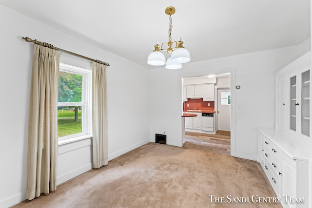 interior space featuring light carpet and a chandelier